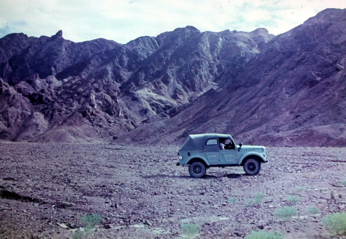 Eastern Desert mountains with an off-road vehicle in a valley